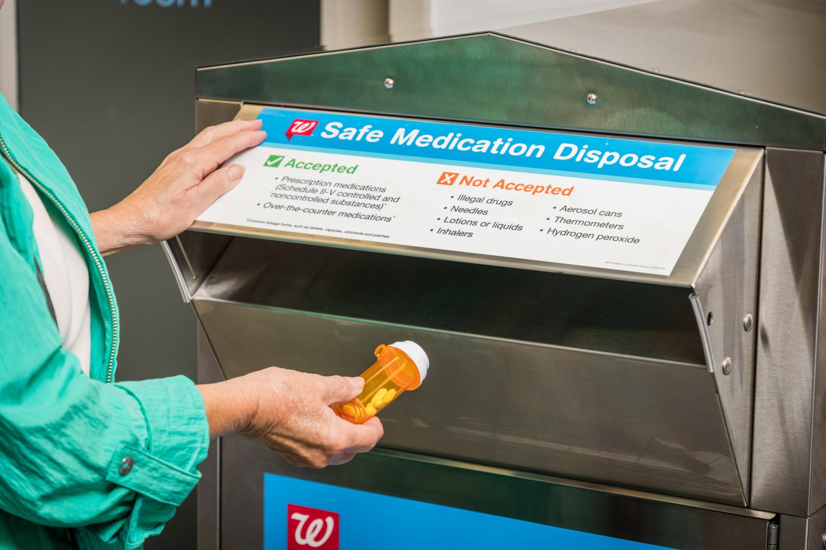 Person placing Walgreens disposal kiosk