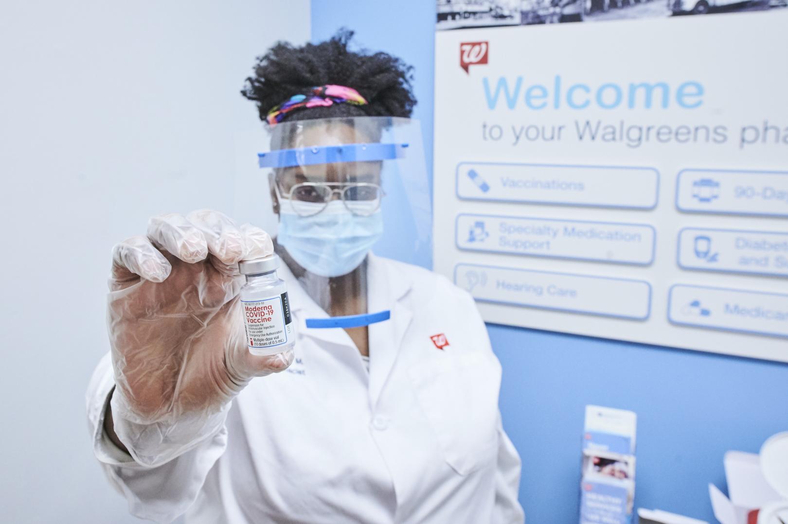 Female pharmacist holding Moderna vaccine vial