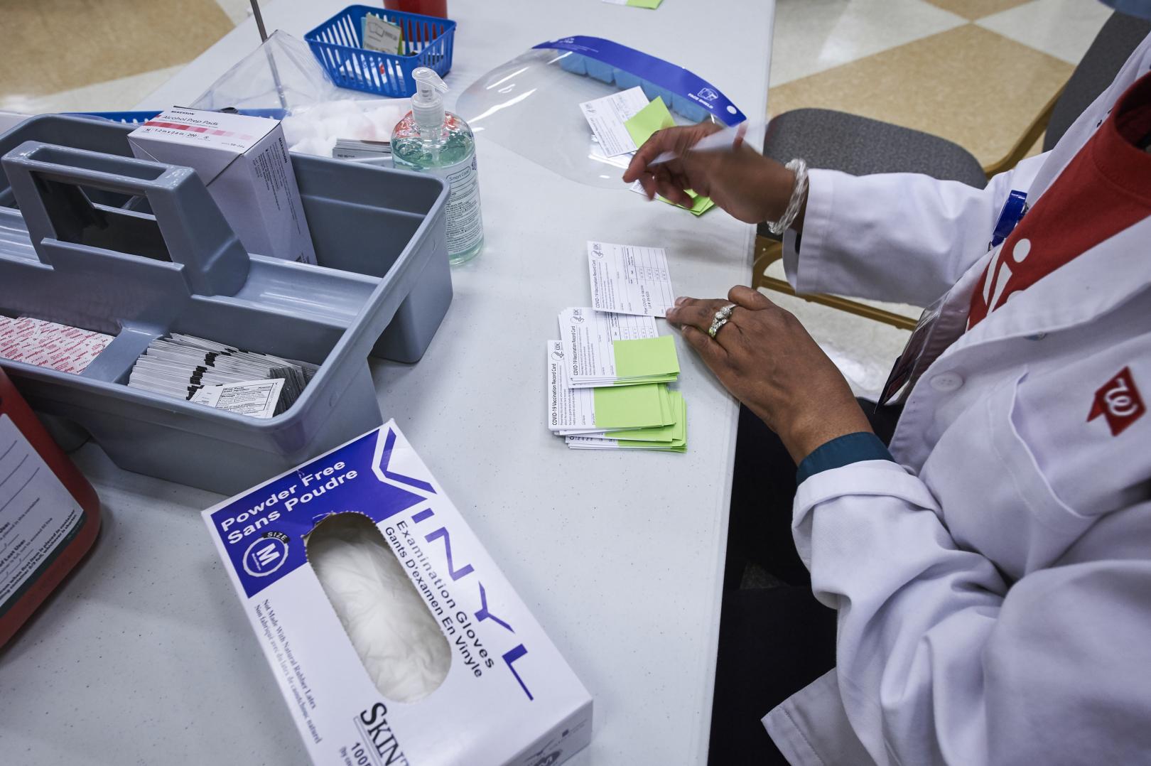 Pharmacist manages vaccination cards