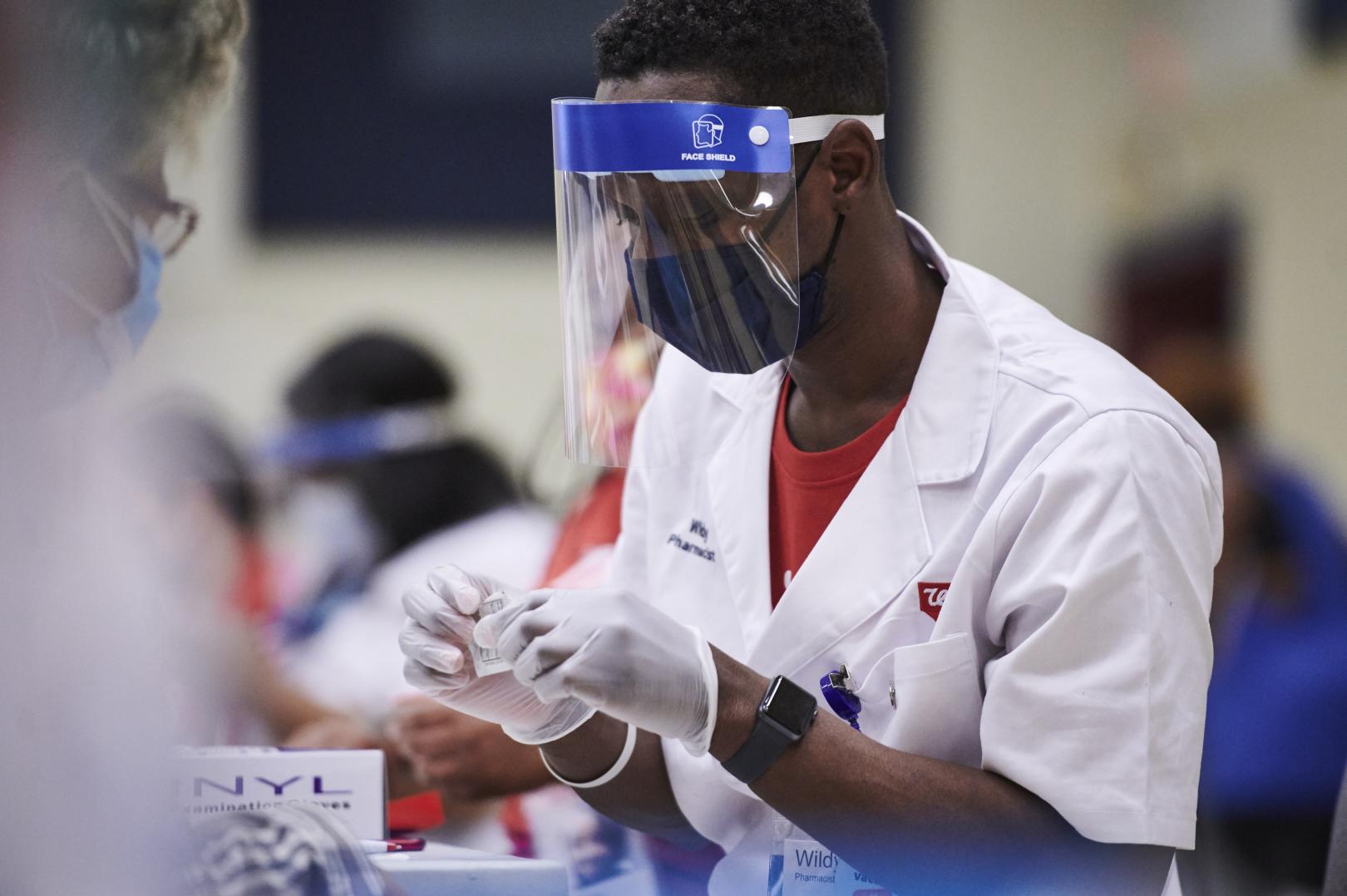 Male pharmacist with face shield