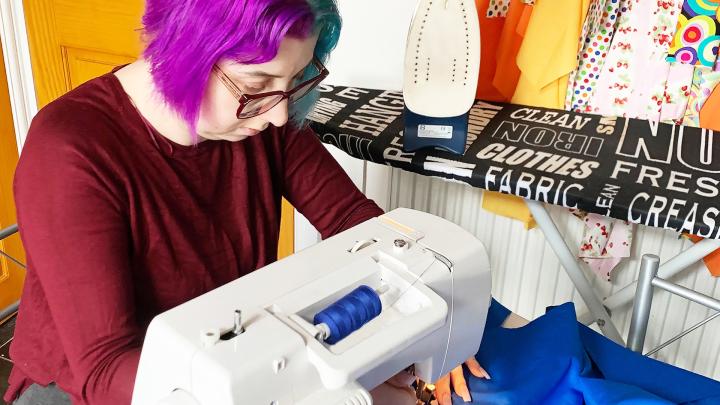 Elise at sewing machine making face masks