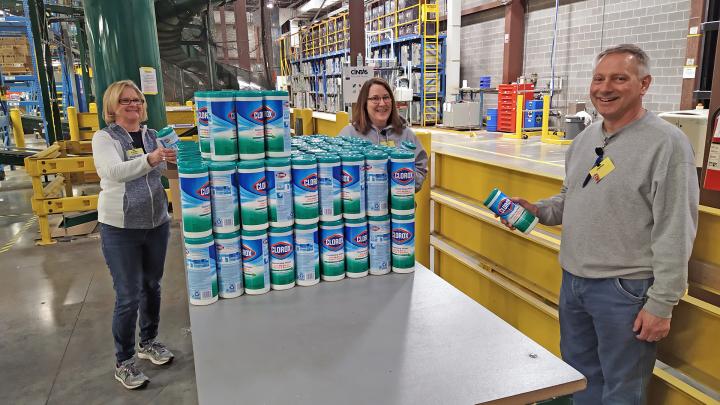 Workers at U.S. distribution center smiling at the camera