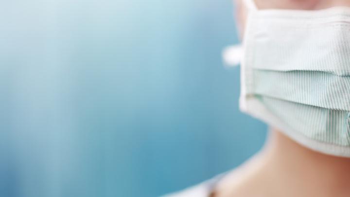 Close up of a woman wearing a face mask