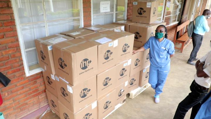 International Health Partners charity volunteer handling boxes with donations