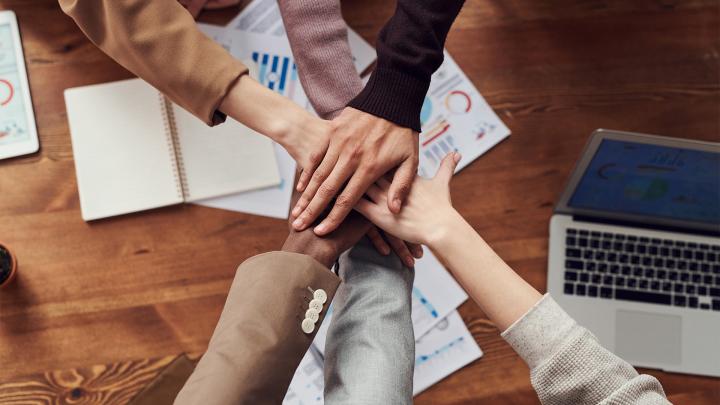 Joining of hands to illustrate inclusion