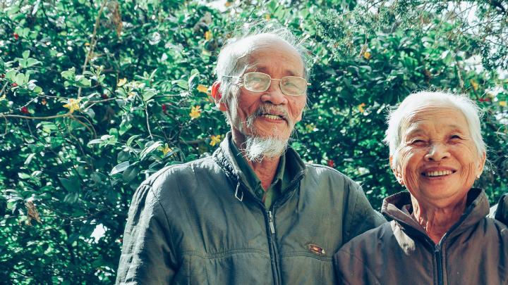 Old couple smiling at the camera