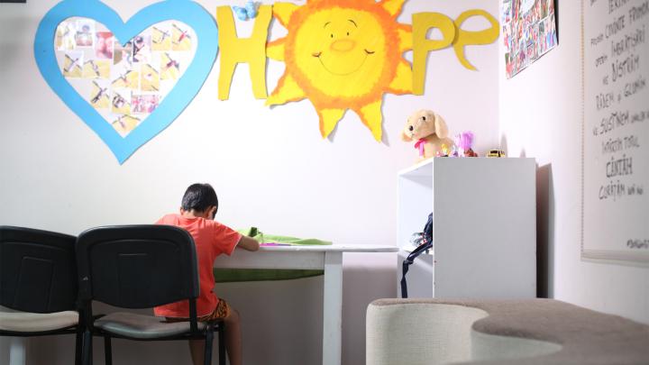 Boy alone at a desk