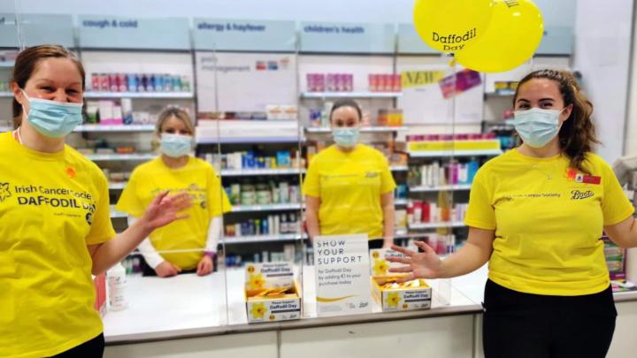 Employees holding balloons for Daffodil Day.