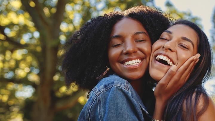 Two women hugging and smiling