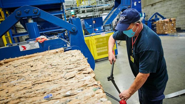 a man recycling paper waste