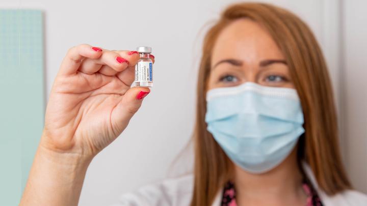 Pharmacist holding phial of Janssen COVID-19 vaccine