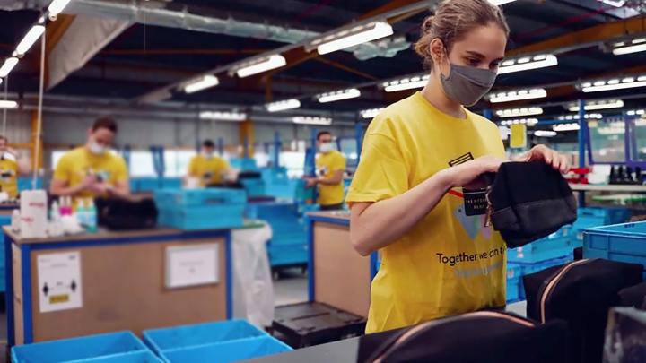 Woman packing products into wash bag