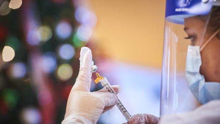 WBA pharmacist holding vaccine